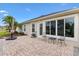 Brick patio with tropical landscaping, offering a private and serene outdoor space at 1376 Birdsong Pl, The Villages, FL 32163