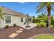 Lush backyard with a brick patio and tropical landscaping, creating a tranquil outdoor oasis at 1376 Birdsong Pl, The Villages, FL 32163
