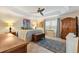 Cozy bedroom with tray ceiling, large windows, and decorative furnishings at 1376 Birdsong Pl, The Villages, FL 32163