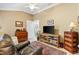 Bonus room featuring seating area, a wooden cabinet, an area rug and lots of natural light at 1376 Birdsong Pl, The Villages, FL 32163