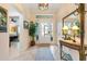 Bright foyer with tile flooring, decorative lighting, and a view towards the bedrooms at 1376 Birdsong Pl, The Villages, FL 32163