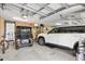 Spacious two car garage featuring golf cart and bicycle storage, and access to overhead storage racks at 1376 Birdsong Pl, The Villages, FL 32163