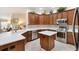 Bright kitchen featuring stainless appliances, a central island, and ample counter space at 1376 Birdsong Pl, The Villages, FL 32163