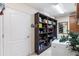 Functional laundry area with a built-in bookshelf, offering storage and convenience at 1376 Birdsong Pl, The Villages, FL 32163