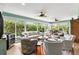 Spacious living room with large windows offering natural light and views of the lush landscaping at 1376 Birdsong Pl, The Villages, FL 32163