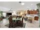 Open floor plan from living room to kitchen, dining, and skylight at 1376 Birdsong Pl, The Villages, FL 32163
