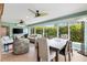 Inviting living and dining area featuring large windows with views of the greenery outside at 1376 Birdsong Pl, The Villages, FL 32163