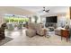 Bright living room showcasing an open floor plan and access to outdoor seating area at 1376 Birdsong Pl, The Villages, FL 32163