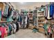 Well-organized walk-in closet with ample shelving and hanging space for clothing, shoes, and accessories at 1376 Birdsong Pl, The Villages, FL 32163