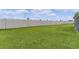 Well-manicured backyard featuring a privacy fence and lush green lawn, perfect for outdoor activities at 1449 Jeremy Cir, The Villages, FL 34762