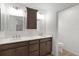 Bathroom with a double vanity, framed mirrors, and dark wood cabinetry at 1449 Jeremy Cir, The Villages, FL 34762