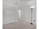 Spacious bedroom features neutral carpeting, a closet and a stylish floor lamp at 1449 Jeremy Cir, The Villages, FL 34762