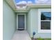 Close-up of the front door with adjacent window under the eave at 1449 Jeremy Cir, The Villages, FL 34762