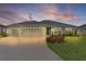 Charming one-story home featuring a two-car garage and well-maintained landscaping at 1449 Jeremy Cir, The Villages, FL 34762