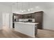 Bright modern kitchen featuring stainless appliances, island, and dark wood cabinetry at 1449 Jeremy Cir, The Villages, FL 34762