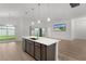 Well-lit, open floor plan featuring a modern kitchen with a central island and backyard access at 1449 Jeremy Cir, The Villages, FL 34762
