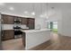 Well-equipped kitchen featuring an island and modern appliances with backyard view at 1449 Jeremy Cir, The Villages, FL 34762