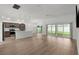 Spacious open-concept living room connecting the kitchen and backyard via sliding glass doors at 1449 Jeremy Cir, The Villages, FL 34762