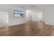 Bright living room with light wood floors and a view of the home on TV at 1449 Jeremy Cir, The Villages, FL 34762