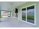 Covered patio with ceiling fans and sliding glass doors offering seamless indoor-outdoor living at 1449 Jeremy Cir, The Villages, FL 34762