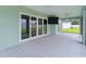 A spacious covered patio featuring ceiling fans and sliding glass doors with backyard views at 1449 Jeremy Cir, The Villages, FL 34762