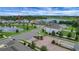 Aerial view of a house with a lake view in a neighborhood with gated entrance at 14501 Wabasso Loop, Winter Garden, FL 34787