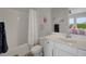 Charming bathroom with a bathtub, white vanity, patterned tile floors, and a decorative mirror at 14501 Wabasso Loop, Winter Garden, FL 34787