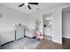 Cozy bedroom featuring a crib and dresser set, with a bathroom leading to patterned tiles floors at 14501 Wabasso Loop, Winter Garden, FL 34787