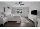 Cozy bedroom featuring hardwood floors, a plush bed, and a window with a view of lush greenery at 14501 Wabasso Loop, Winter Garden, FL 34787