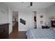 Comfortable bedroom shows 'Play Ball' decor, wooden floors, and access to the upper level at 14501 Wabasso Loop, Winter Garden, FL 34787