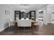 Elegant dining room with wood table and chairs, a unique chandelier, and a built-in fish tank feature at 14501 Wabasso Loop, Winter Garden, FL 34787