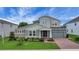 Stunning two-story home featuring a brick driveway, a two-car garage, and a beautifully landscaped yard at 14501 Wabasso Loop, Winter Garden, FL 34787