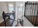 View of the foyer from the staircase that features hardwood steps, a chandelier, and wrought iron railings at 14501 Wabasso Loop, Winter Garden, FL 34787