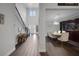 Spacious foyer with wood-like floors, a staircase, and a view of the dining room and living space at 14501 Wabasso Loop, Winter Garden, FL 34787