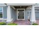 Elegant front door with sidelights, framed by white pillars, and a brick walkway leading to the entrance at 14501 Wabasso Loop, Winter Garden, FL 34787