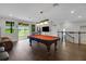 Bright game room with a pool table, seating, and outdoor access at 14501 Wabasso Loop, Winter Garden, FL 34787