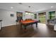 Bright game room featuring a pool table, bar area, and access to the outdoor patio at 14501 Wabasso Loop, Winter Garden, FL 34787