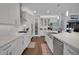Modern white kitchen features stainless steel appliances, a spacious island, and stylish countertops at 14501 Wabasso Loop, Winter Garden, FL 34787