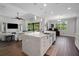 Open concept living space with white kitchen island, stainless steel sink, and ample countertop space at 14501 Wabasso Loop, Winter Garden, FL 34787