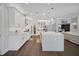 Large white kitchen with modern stainless steel appliances, an island, and white cabinetry at 14501 Wabasso Loop, Winter Garden, FL 34787