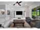 Bright living room with large TV, ceiling fan, and sliding glass doors to the outdoor area at 14501 Wabasso Loop, Winter Garden, FL 34787