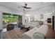 Open-concept living room with a view of the kitchen and a stunning outdoor pool with waterfall at 14501 Wabasso Loop, Winter Garden, FL 34787