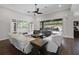 Living room with white sofas, dark wood floors, and a view of the waterfall pool at 14501 Wabasso Loop, Winter Garden, FL 34787