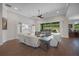 Bright living room features hardwood floors, large windows, and comfortable seating at 14501 Wabasso Loop, Winter Garden, FL 34787
