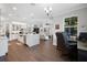 Open-concept living space with modern kitchen, island, and connected living area with wood floors at 14501 Wabasso Loop, Winter Garden, FL 34787
