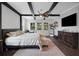 Spacious main bedroom features dark wood-look floors and ceiling beams plus ample natural light at 14501 Wabasso Loop, Winter Garden, FL 34787