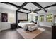 Stunning main bedroom featuring wood beams, neutral decor, bench seat and an ensuite bath at 14501 Wabasso Loop, Winter Garden, FL 34787