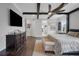 Spacious main bedroom features dark wood-look floors and ceiling beams plus ample natural light at 14501 Wabasso Loop, Winter Garden, FL 34787