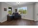 Office with wood-look flooring and a dark wood desk with a large window offering a beautiful view at 14501 Wabasso Loop, Winter Garden, FL 34787