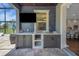 The outdoor kitchen has marble counters, a sink, and built in cabinets at 14501 Wabasso Loop, Winter Garden, FL 34787